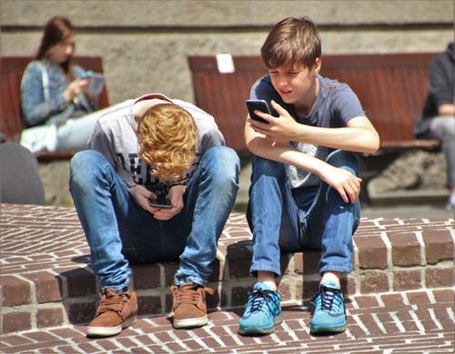 2 drenge med mobiltelefoner